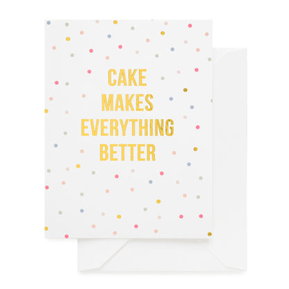 white card with multicolored dots and gold text, white envelope