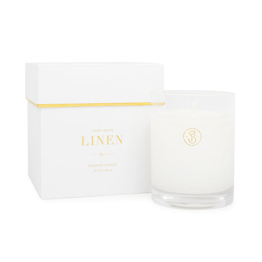 White linen candle with a white box with gold foil detail