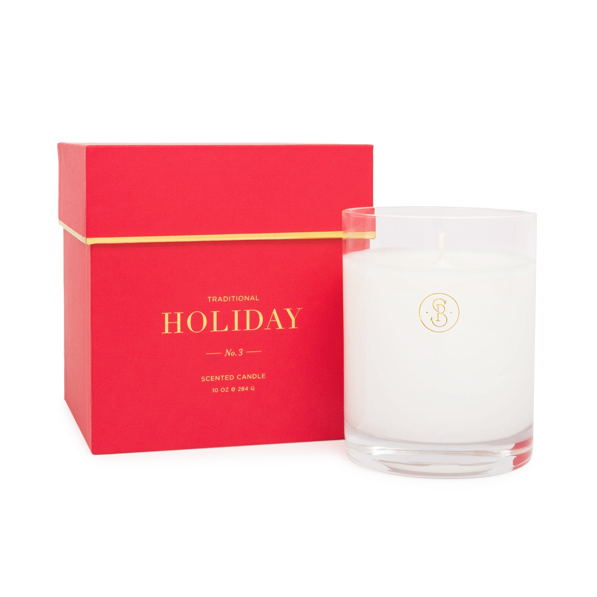 Glass candle next to red candle box - holiday fir scent