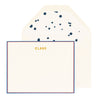 cream card with navy and red border and gold text, cream envelope with navy splatter liner