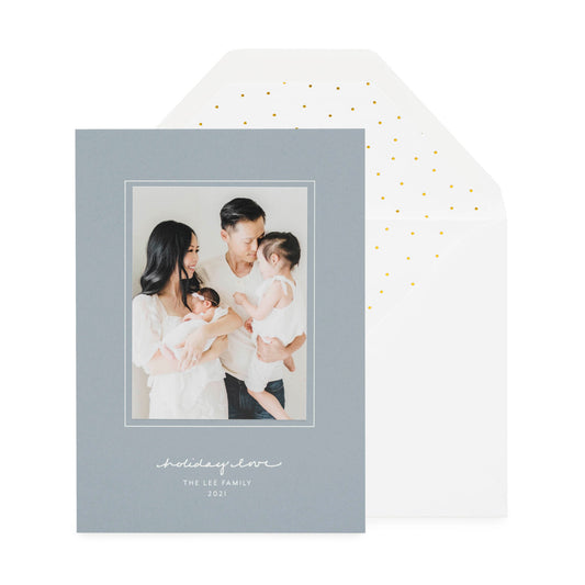 slate blue card with photo and white text, white envelope with gold scatter dot liner