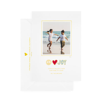 white card with photo and multicolor text, white envelope with gold text