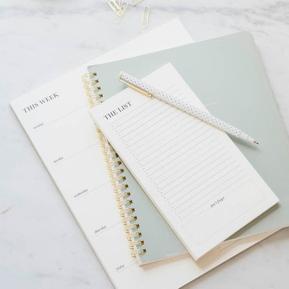 Black and cream list pads with office green notebook