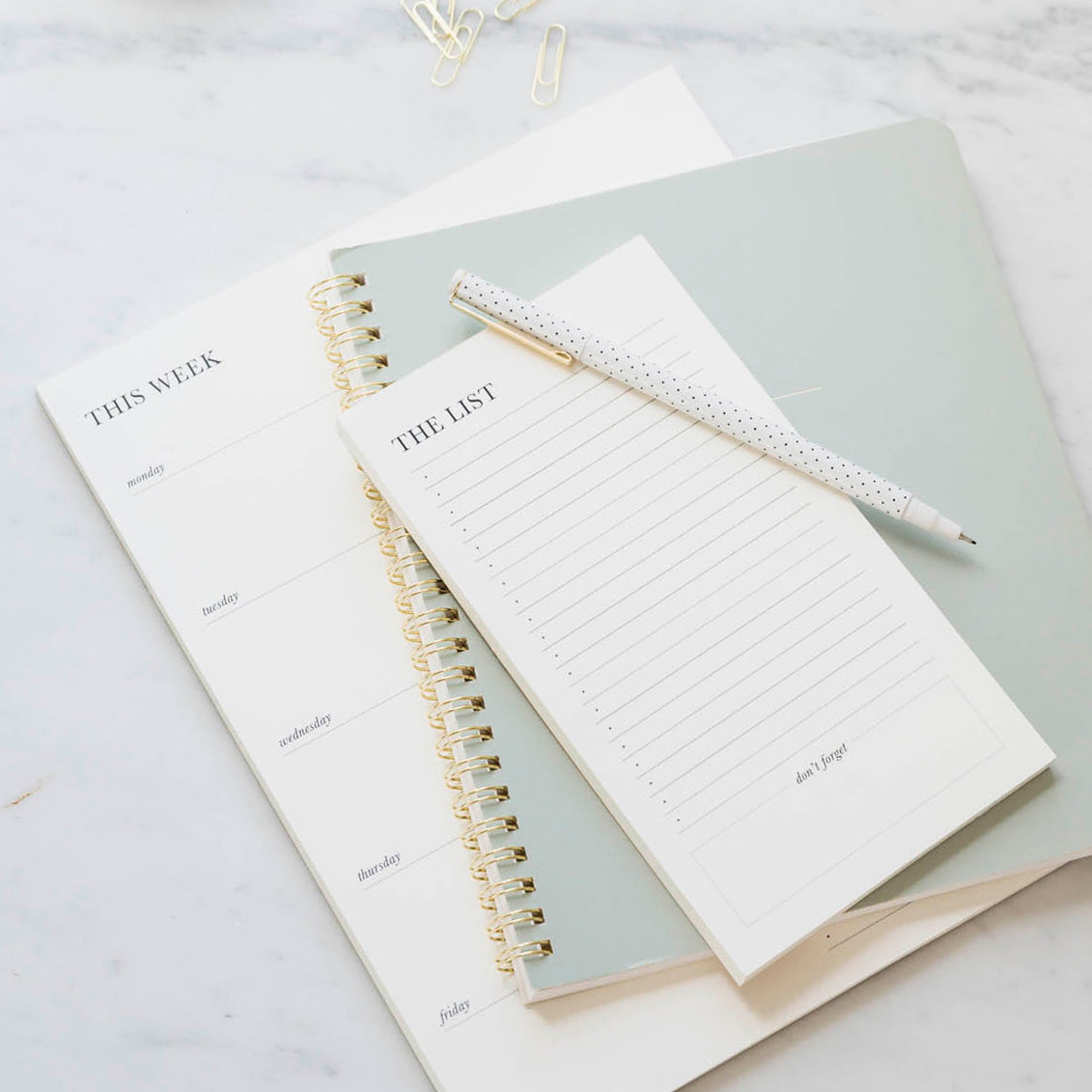 Black and cream list pads with office green notebook