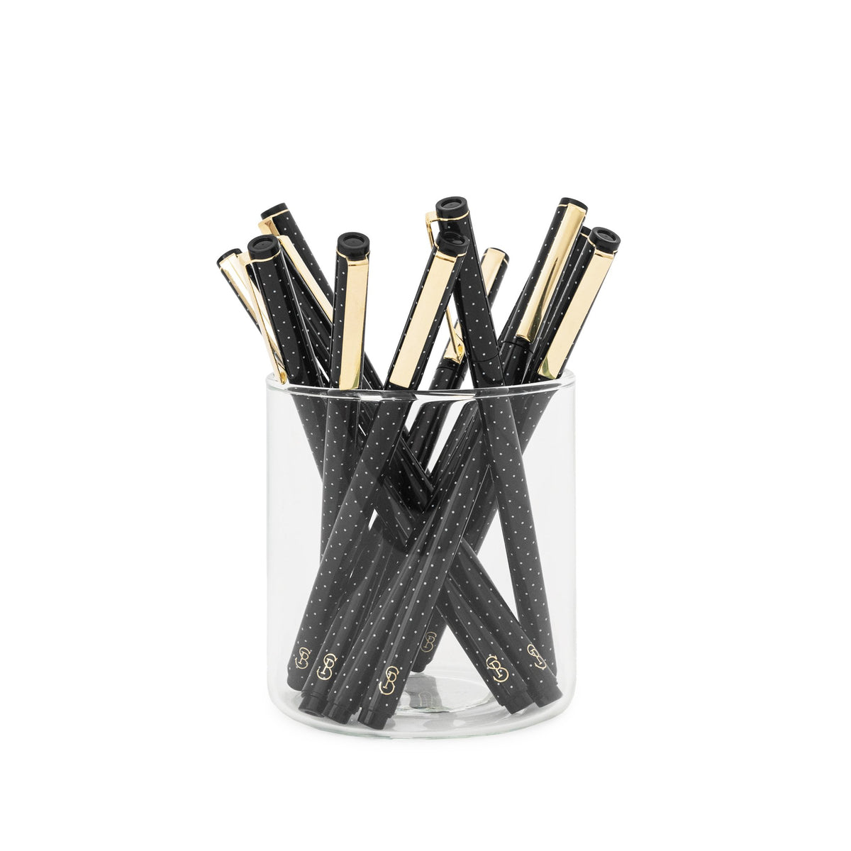 Black and white dot felt pens in glass cup