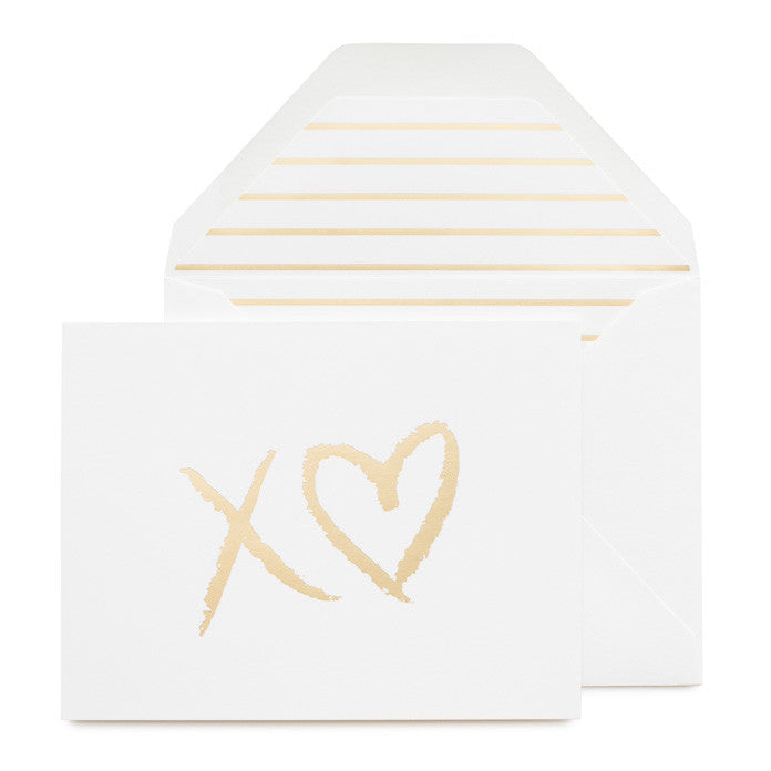 Folded white card with XO printed in gold foil