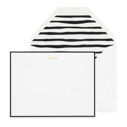 white card with gold foil and black border, white envelope with black painterly stripe liner