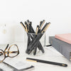 Desk image of black felt tip pens