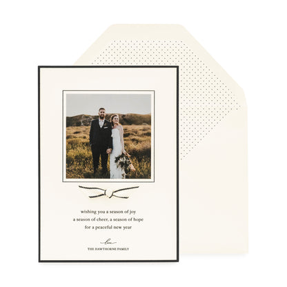 Cream and black holiday photo card paired with a black and cream ribbon