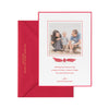 Red holiday photo card with a red and white ribbon showing detail of the gold foil on the envelope.