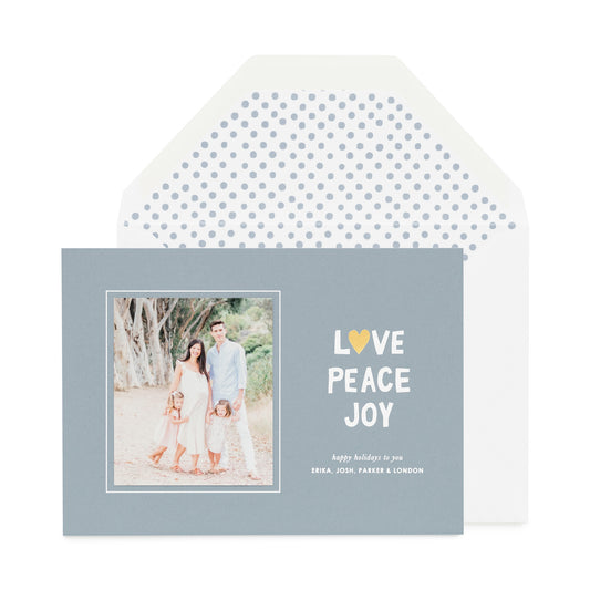 Blue holiday photo card with Love Peace Joy and dot envelope liner.