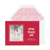 Red holiday photo card with Love Peace Joy and dot envelope liner.