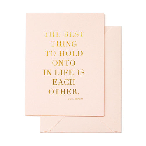 Pale pink card printed in gold foil with "The Best Thing to Hold Onto in life is each other