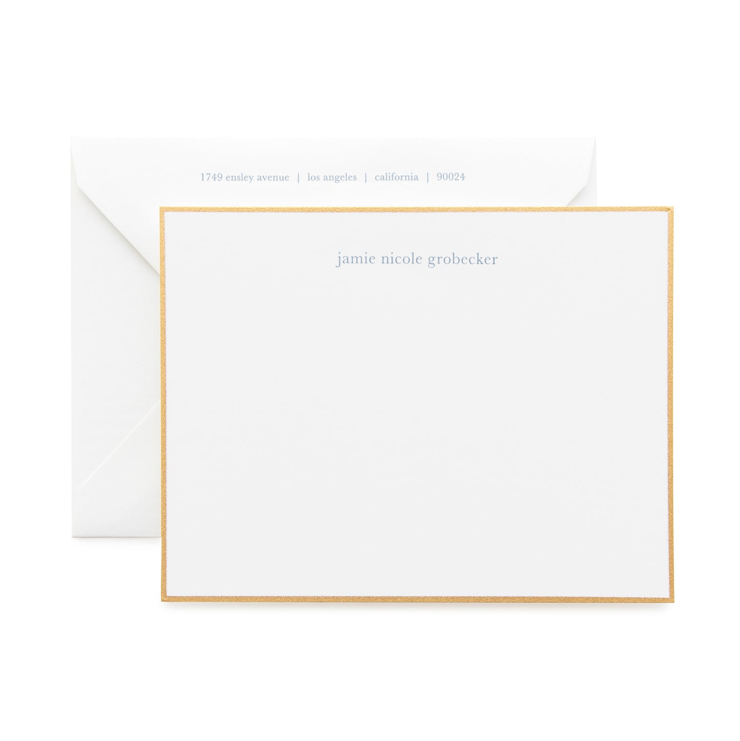 Dusty blue and white custom stationery with return address showing on envelope