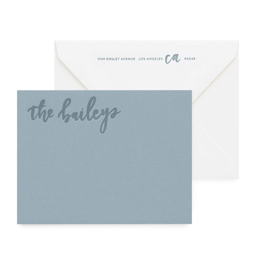 slate blue card with tonal text, white envelope
