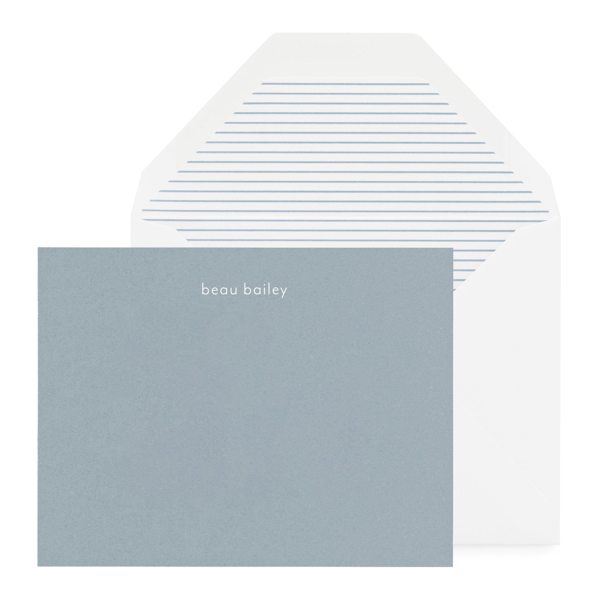Slate blue stationery with white foil name and blue and white striped envelope liner