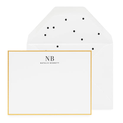 Black and white custom stationery with gold border and black polka dot liner