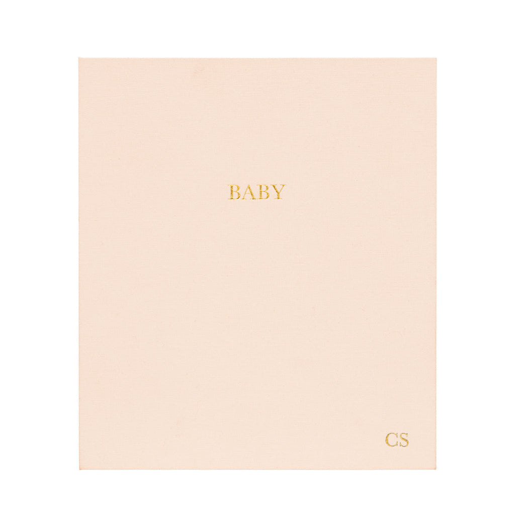 This is the cover of our baby book in a pale pink color for a baby girl. #color_pale-pink