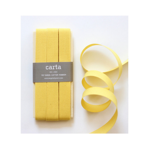 Lemon yellow cotton ribbon on wood paddle