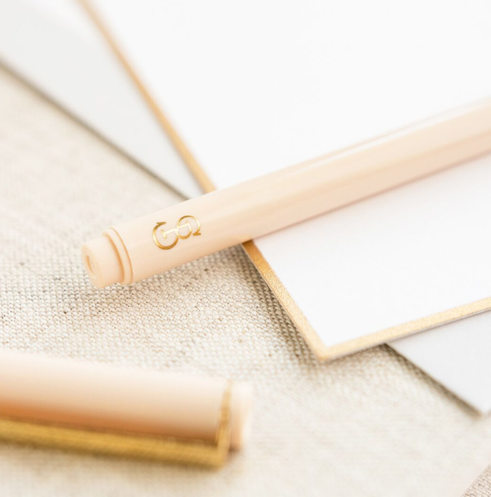 Pale pink pen with gold logo
