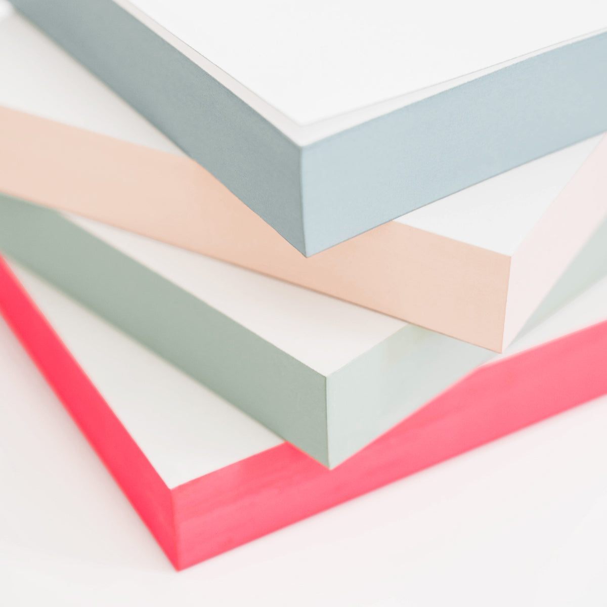 Stack of painted notepads in various colors