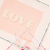 closeup of pink love needlepoint kit