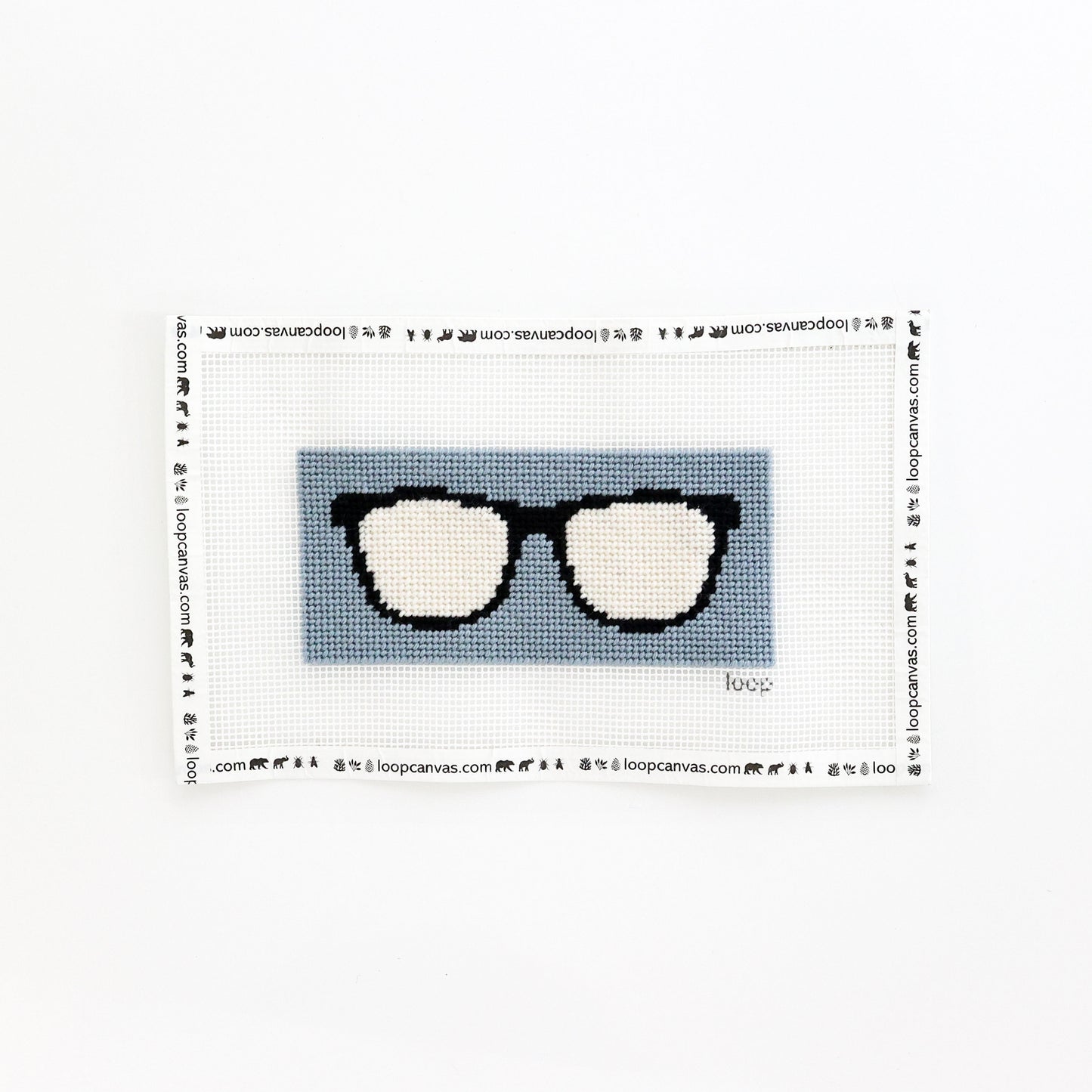 completed dusty blue sunglasses needlepoint kit