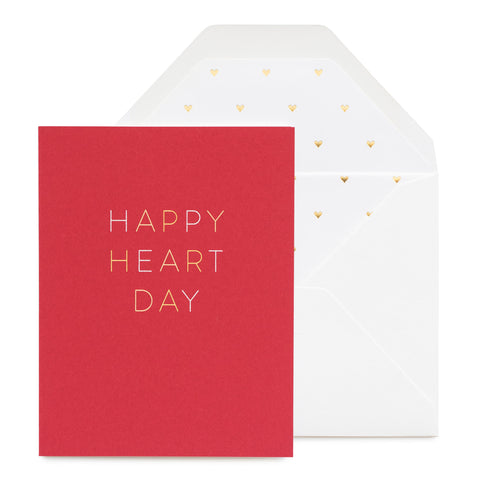Red card printed in white and gold foil with Happy Heart Day with a heart gold foil liner