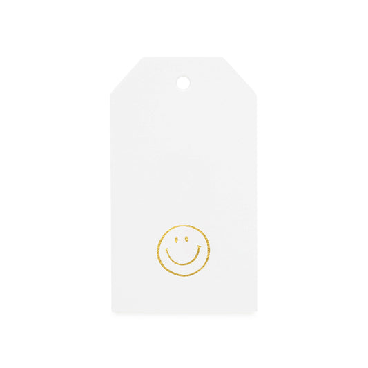white gift tag with gold foil smiley face