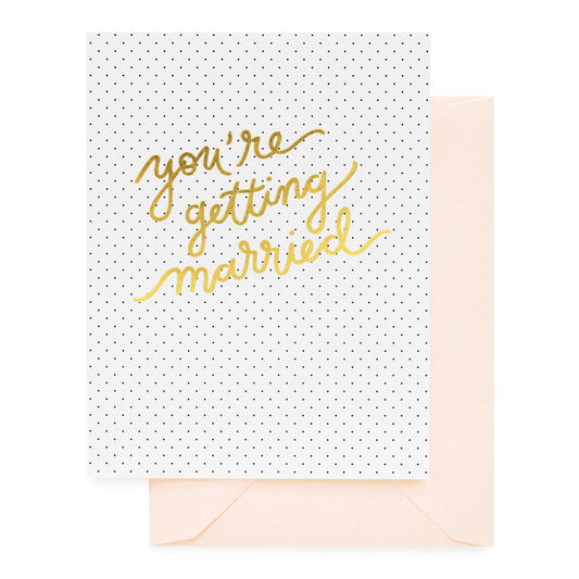 Black pindots on white folded card printed with you're getting married.